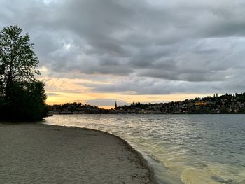 Scenic view of beach against sky during sunset