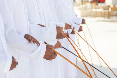 White image of people holding umbrella