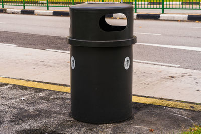 Close-up of garbage bin by street