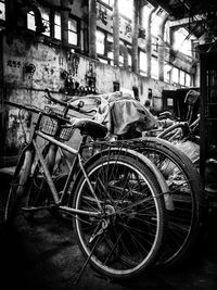 Old bicycle on street against buildings in city