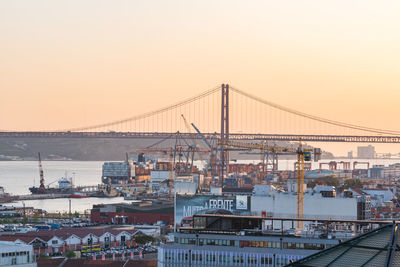 Suspension bridge over river against clear sky