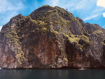 Scenic view of rock formation in sea against sky