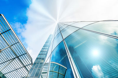 Low angle view of modern glass building against sky