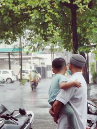 Rear view of people on street in city