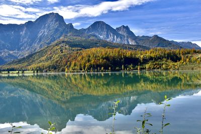 Scenic view of lake and mountains in autumn against sky