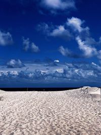 Scenic view of beach against blue sky