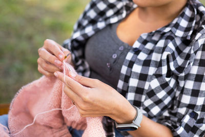 Midsection of woman knitting