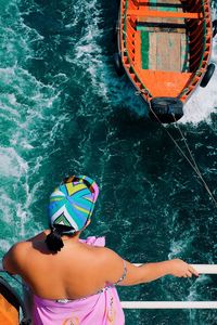 Rear view of woman in boat