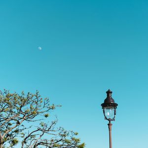 Low angle view of street light against blue sky