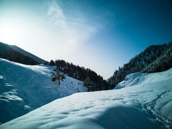 Scenic view of snow covered mountains against sky