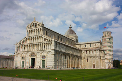 Cathedral of the pisa tower on the grass of piazza dei miracoli in tuscany