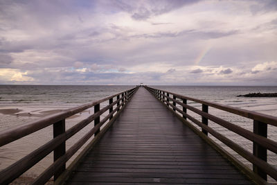 Pier over sea against sky