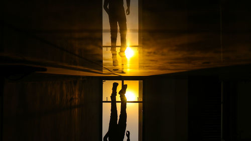 Reflection of man jumping during sunset