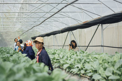 Group of people in greenhouse