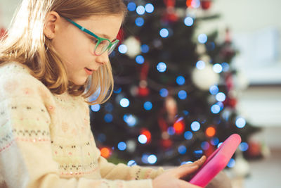 Girl using digital tablet at home during christmas