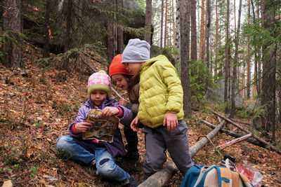 Children with map in forest