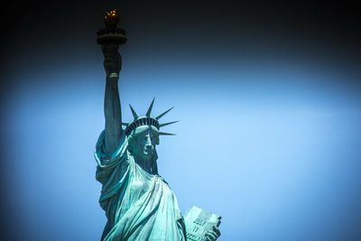 Low angle view of statue against blue sky