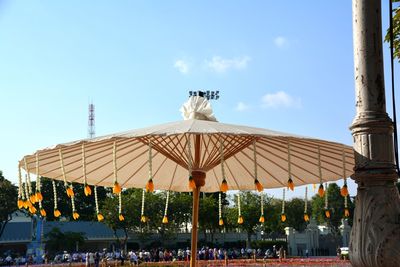 People at amusement park against blue sky