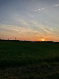 Scenic view of field against sky during sunset