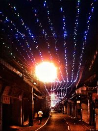 Illuminated tunnel at night