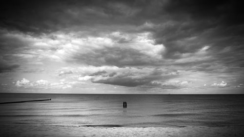 Scenic view of sea against storm clouds