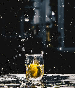 Glass of water splashing on table