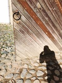 High angle view of shadow of bicycle on footpath