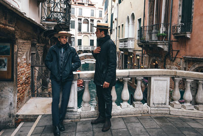 Men standing on street in city