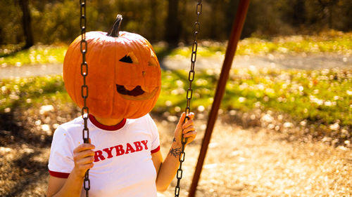Rear view of boy playing in playground