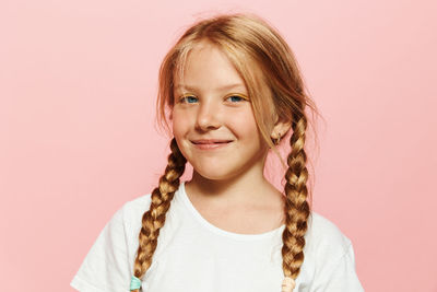 Portrait of young woman against white background