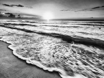 Scenic view of sea against cloudy sky