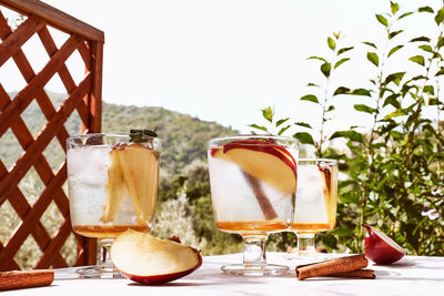 Fresh and healthy cocktail or mocktail with apple, ice, cinnamon and herbs. refreshing summer drink