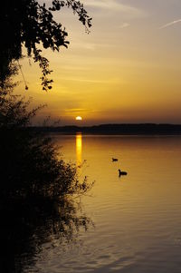 Scenic view of lake against sky during sunset