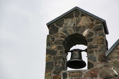 Low angle view of bell tower against sky