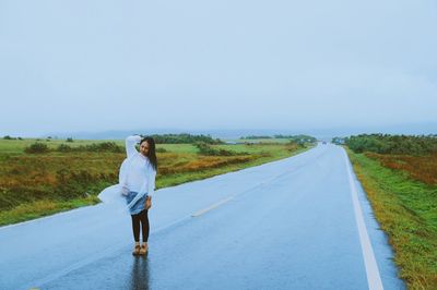 Rear view of man walking on country road