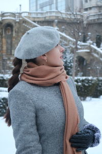 Midsection of person wearing hat standing in snow