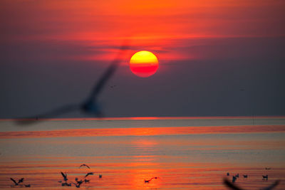 Scenic view of sea against romantic sky at sunset