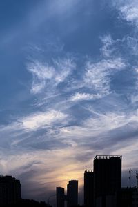 Silhouette buildings against sky during sunset
