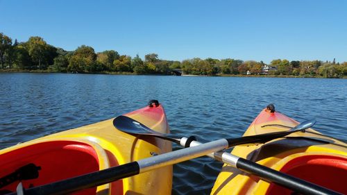 Kayaks moored in lake