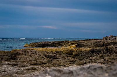 Rocks on beach against sky