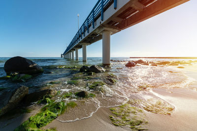 Bridge over sea against clear sky