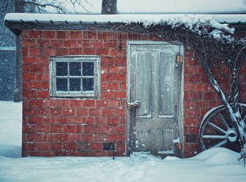 Snow covered brick wall of building