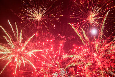 Low angle view of firework display at night