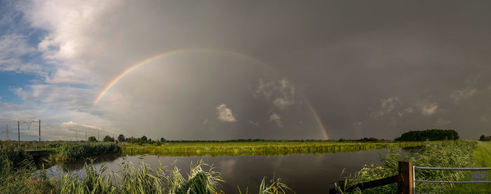 Rainbow over dutch polder landscape