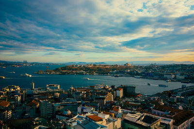 High angle view of townscape by sea against sky