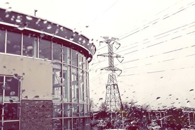 Low angle view of electricity pylon against sky