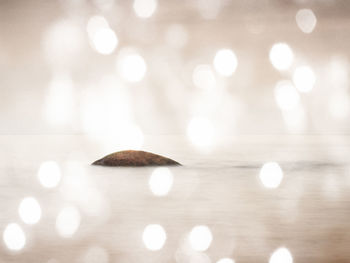 Defocused image of illuminated lights on table