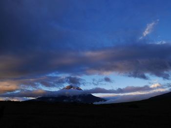 Scenic view of mountains against cloudy sky