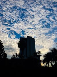 Low angle view of silhouette building against sky at sunset