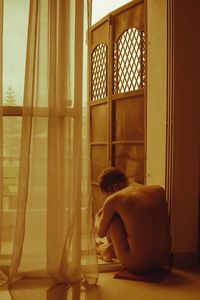 Man sitting by window at home